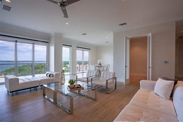 a living room with furniture and large windows