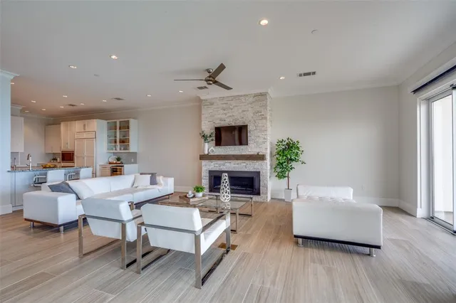 a living room with furniture a fireplace and a flat screen tv