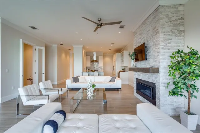 a living room with furniture a fireplace and a flat screen tv