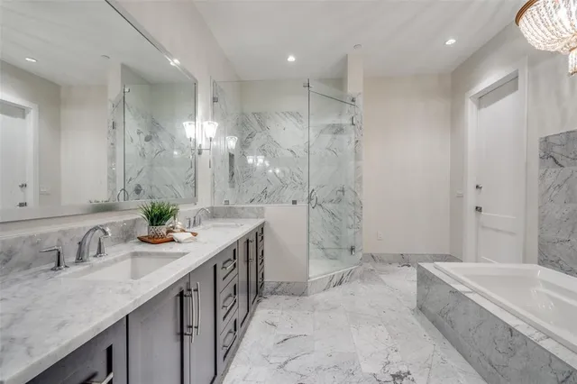a spacious bathroom with a granite countertop sink mirror and a bath tub