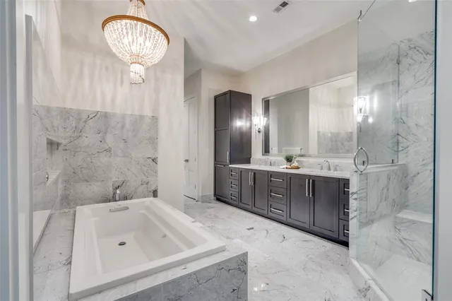 a bathroom with a sink a large mirror and a bathtub