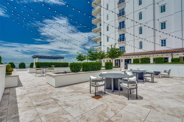 a view of a patio with a table and chairs