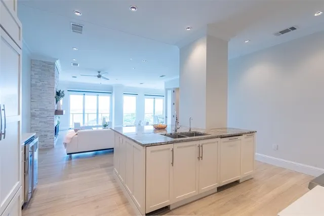 a spacious bathroom with a granite countertop sink a toilet and a bathtub