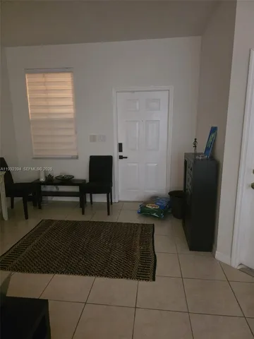 a living room with a black white checkered floor