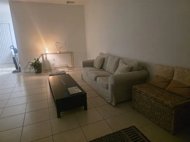 a living room with a couch and a lamp
