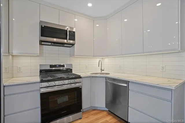 a kitchen with a sink stove and microwave