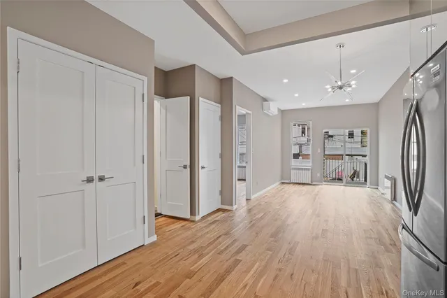 a kitchen with stainless steel appliances a stove a microwave and white cabinets