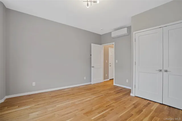 a view of an empty room and wooden floor