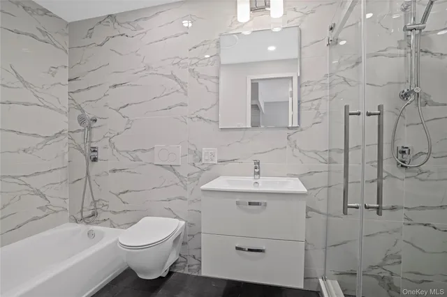 a bathroom with a toilet sink shower and bathtub