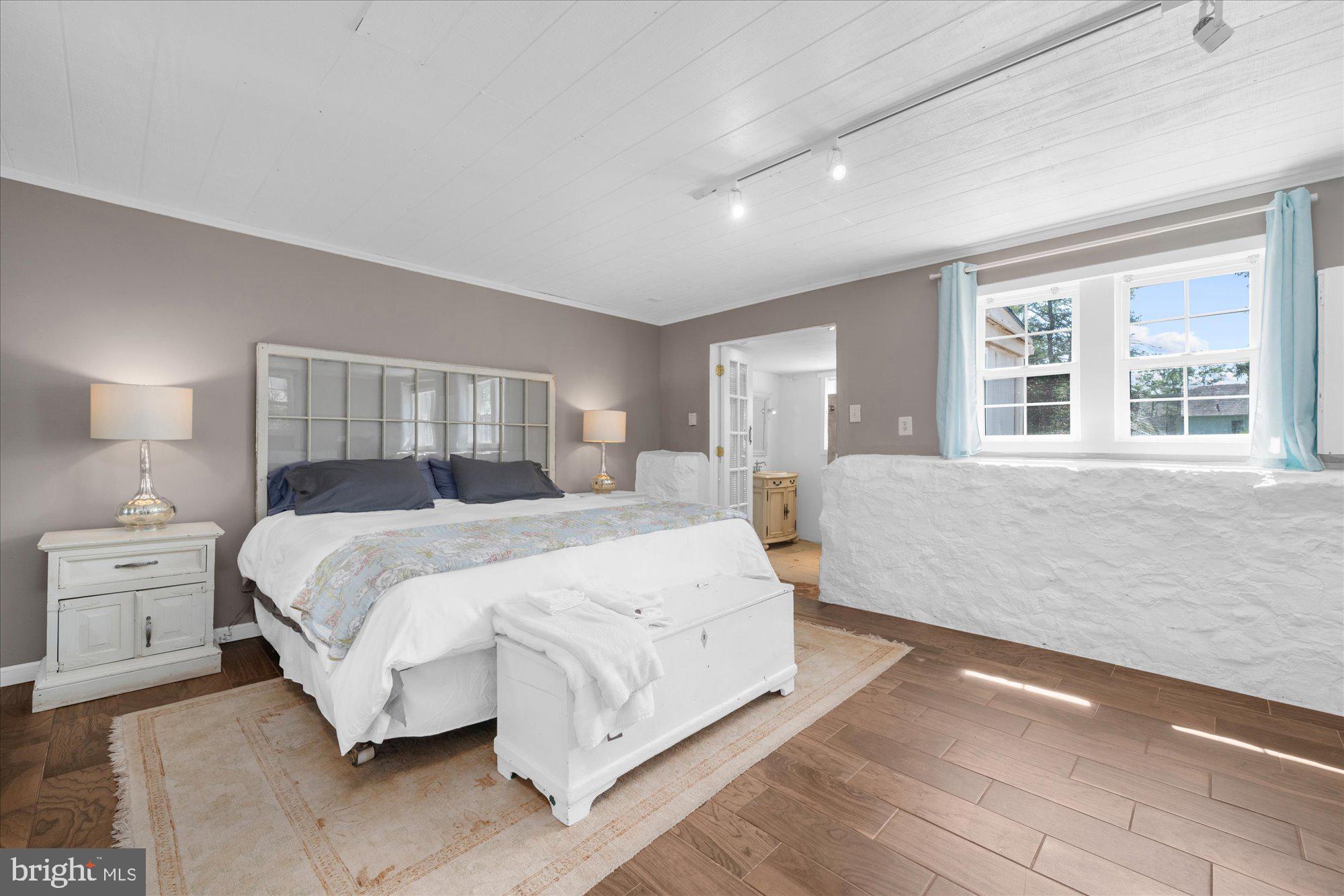 5358 York Road Doylestown, PA 18902 - Photo 42 of 61 a spacious bedroom with a large bed and wooden floor