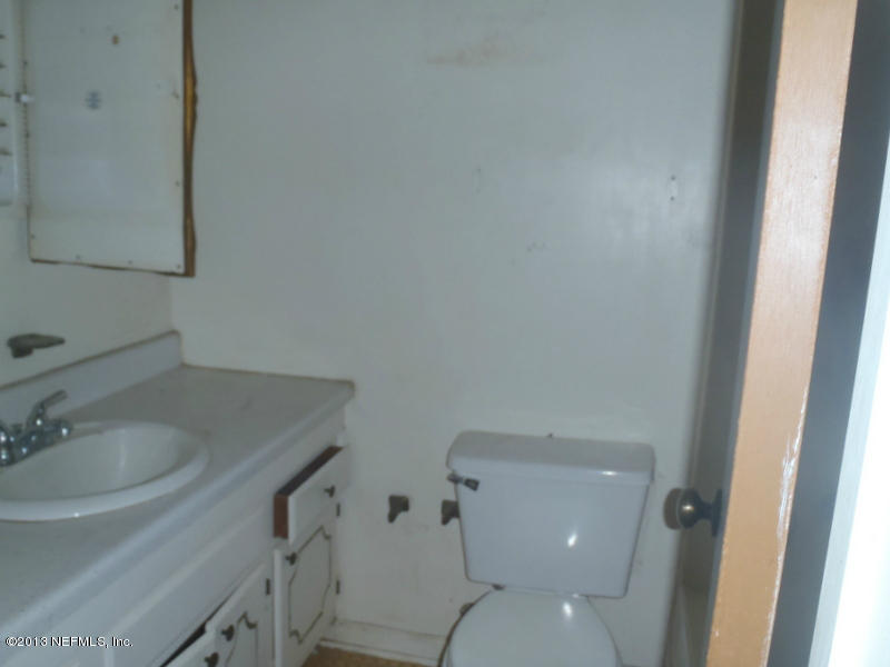 524 Segovia Road St. Augustine, FL 32086 - Photo 12 of 12 a white toilet sitting next to a bathroom sink