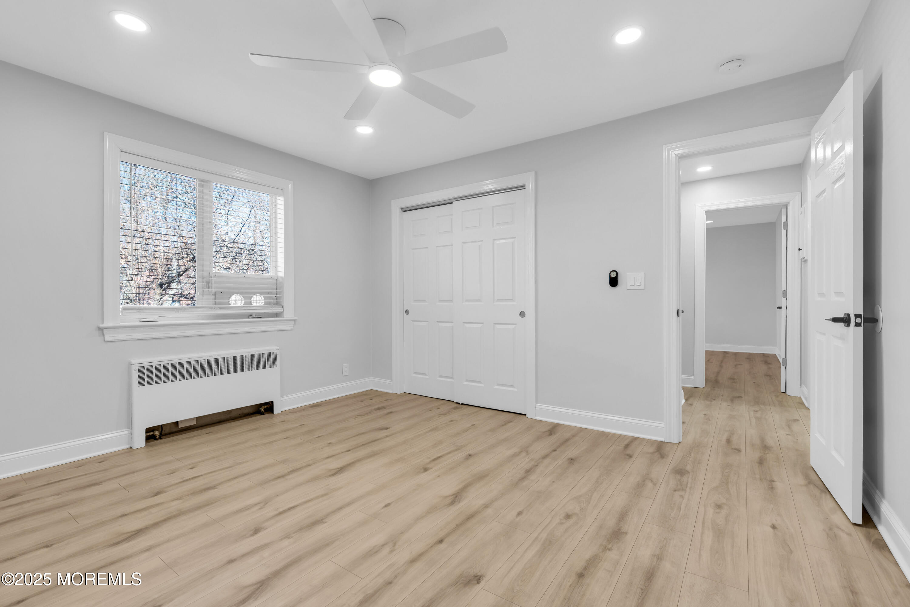 283 Spring Street, Unit 3A Red Bank, NJ 07701 - Photo 11 of 21 wooden floor in an empty room with a window
