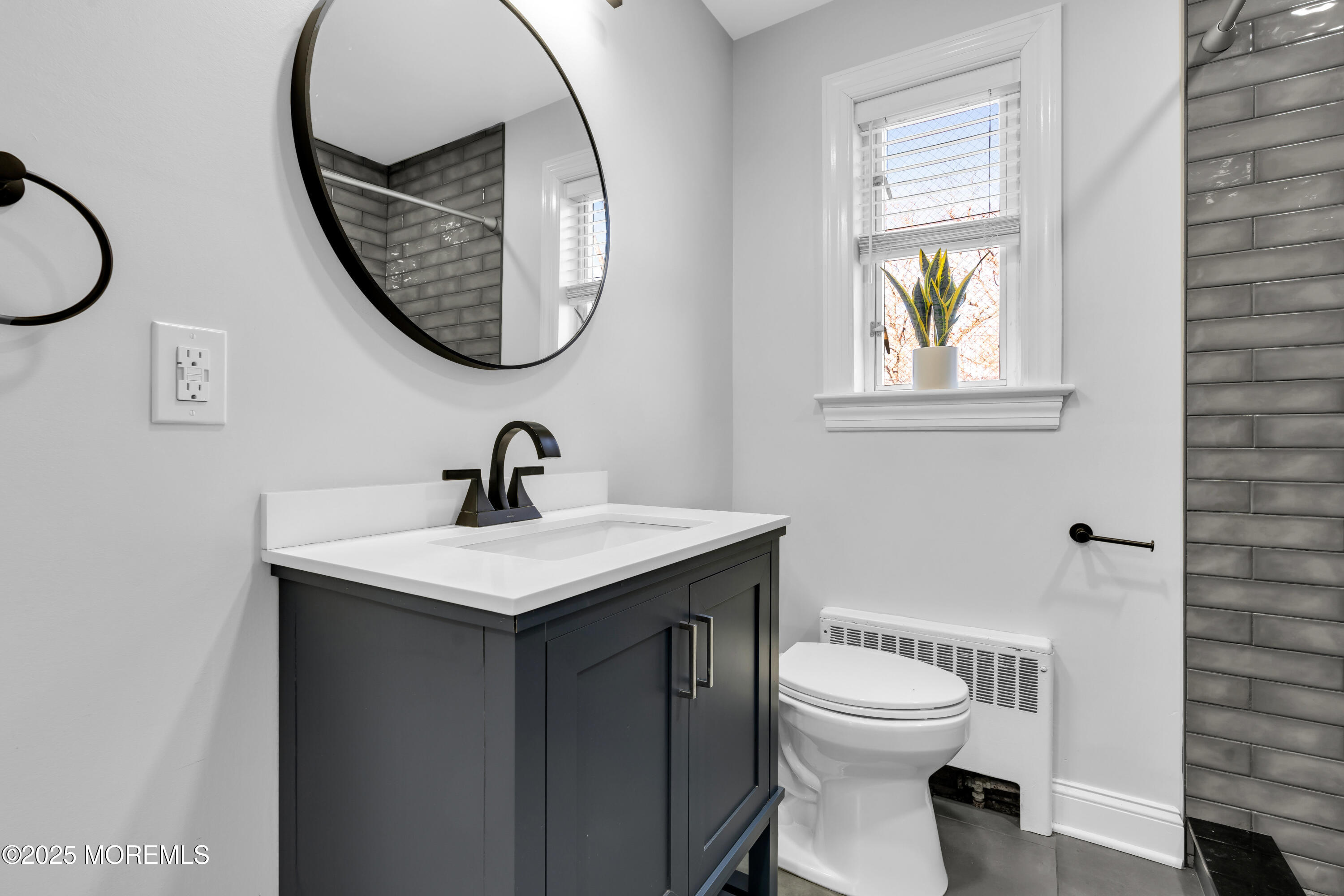 283 Spring Street, Unit 3A Red Bank, NJ 07701 - Photo 12 of 21 a bathroom with a toilet a sink and a mirror