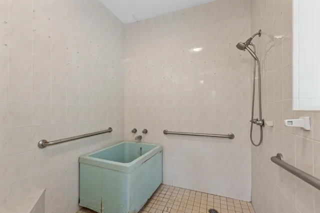 a bathroom with a sink a window and a shower