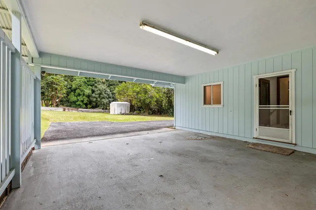 an empty room with floor to ceiling windows and yard