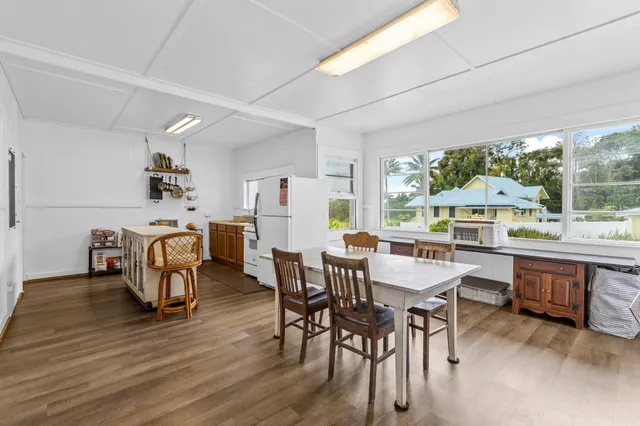a bedroom with a bed a dresser next to a window