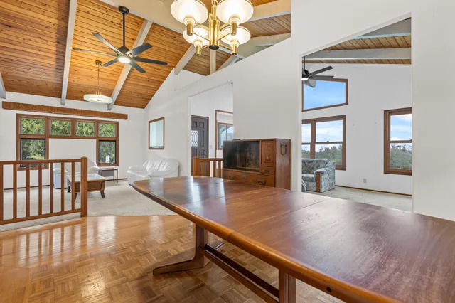 a view of a living room and dining room with wooden floor