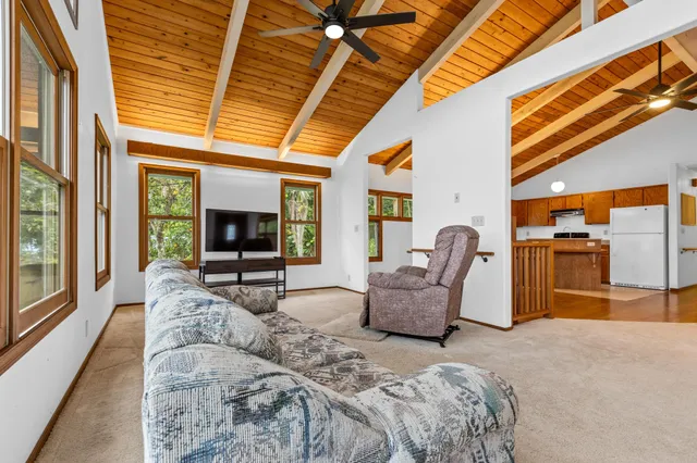 a bedroom with furniture and large windows