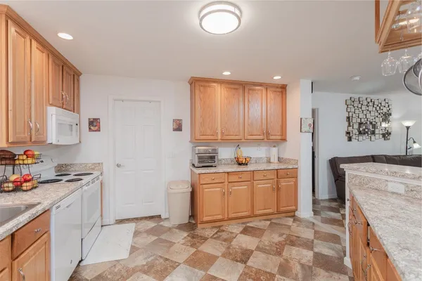 a kitchen with stainless steel appliances granite countertop a stove a sink and a refrigerator