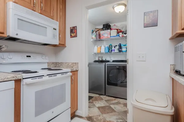 a kitchen with a stove top oven and cabinets
