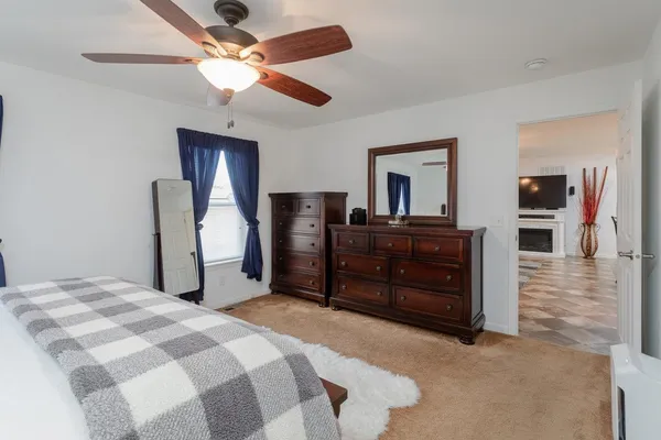 a bedroom with a bed and a dresser