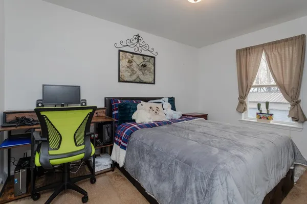 a bedroom with a bed and a table