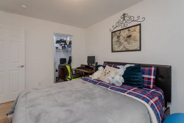 a bed room with a bed and a window