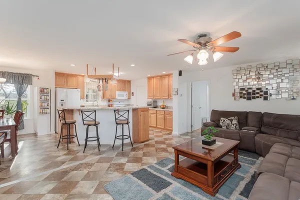 a living room with furniture and kitchen view