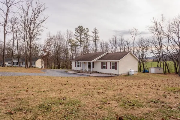a view of a yard with a house in the background