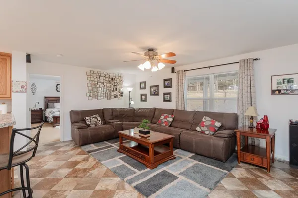 a living room with furniture and a chandelier