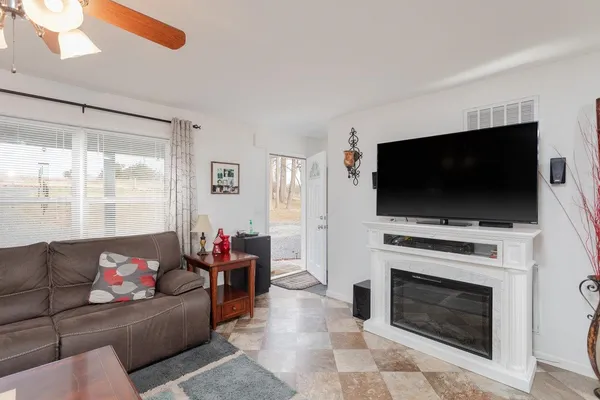 a living room with a fireplace and a flat screen tv