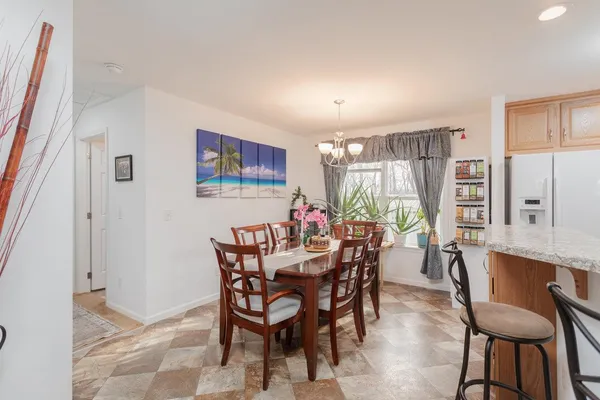 a view of a dining room with furniture and a large window