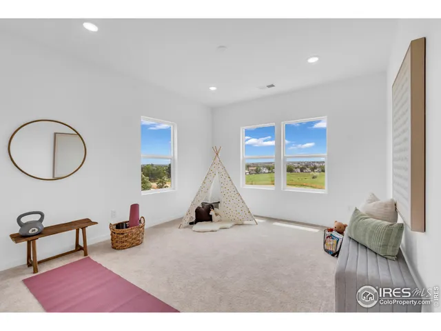 a living room with furniture a window and a flat screen tv