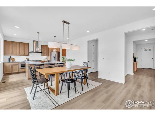 a view of a dining room and livingroom with furniture wooden floor