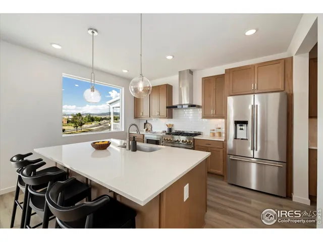 a kitchen with kitchen island a sink appliances and cabinets