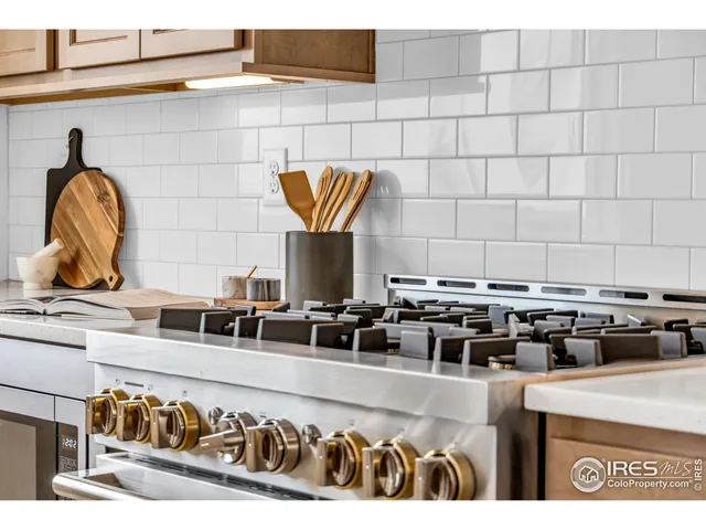 a kitchen with a stove and a white cabinets