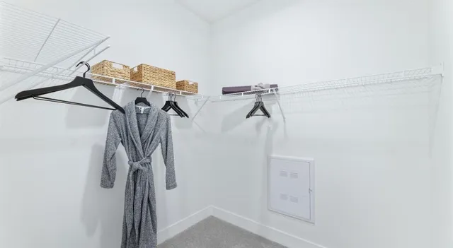 a view of walk in closet with clothes