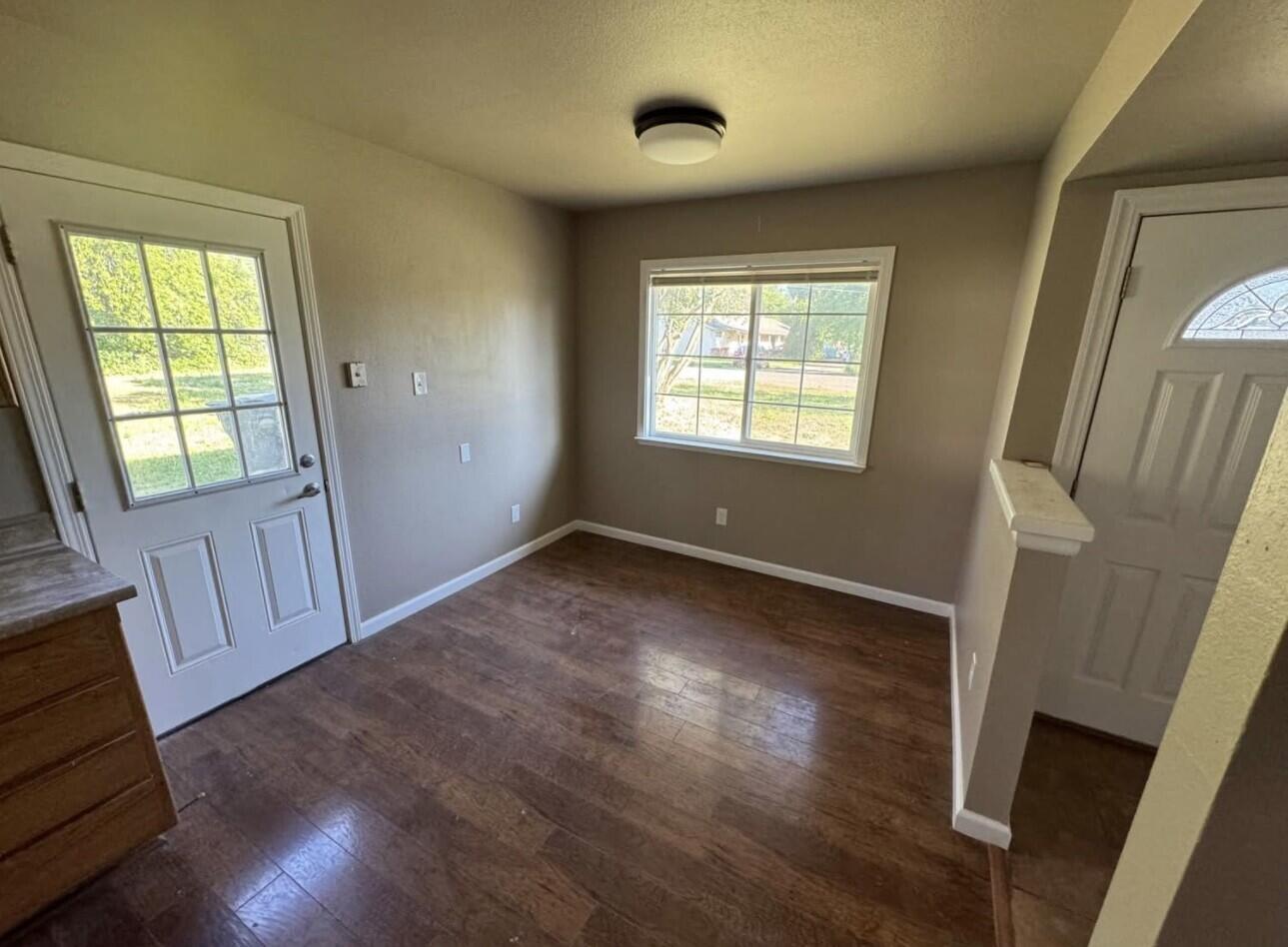 566 Roundup Avenue Red Bluff, CA 96080 - Photo 16 of 16 a view of an empty room with wooden floor and a window