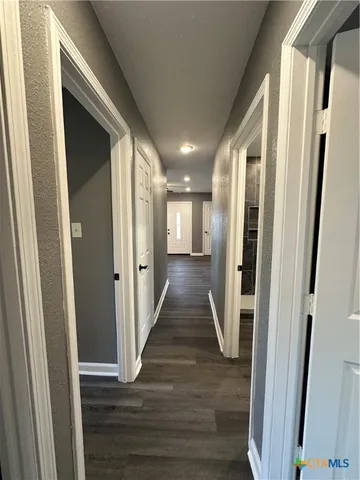 a view of gallery with wooden floor