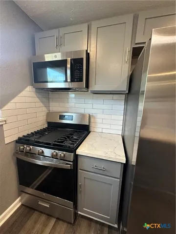 a kitchen with a stove and a microwave
