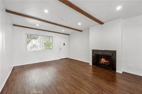 a view of a livingroom with kitchen and furniture