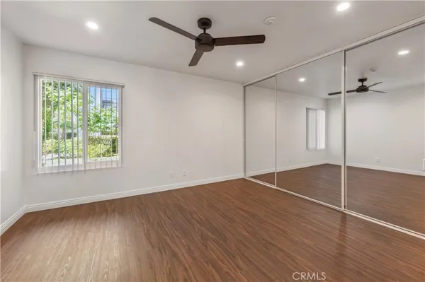 a view of empty room with wooden floor and fireplace
