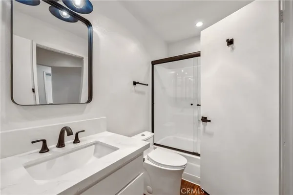 a view of a kitchen with wooden floor and a sink