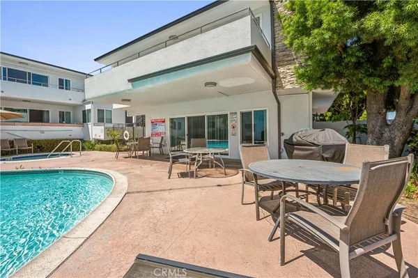 a swimming pool with outdoor seating yard and barbeque oven
