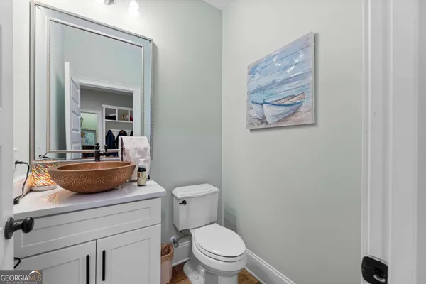 a bathroom with a toilet a sink and mirror