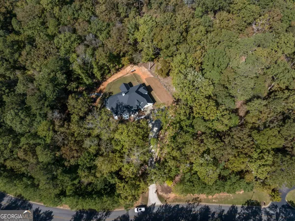 an aerial view of a house with a yard