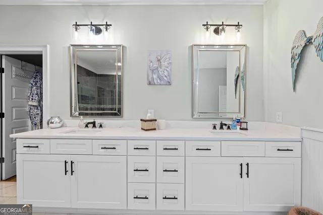 a bathroom with a double vanity sink mirror and