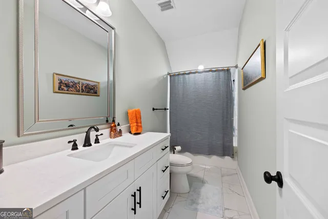 a bedroom with bed and a flat tv screen