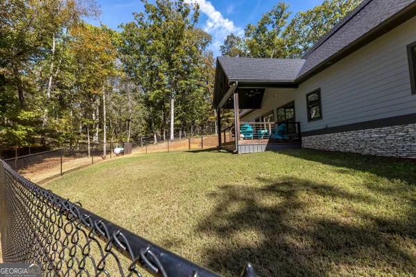 a view of a house with backyard and sitting area