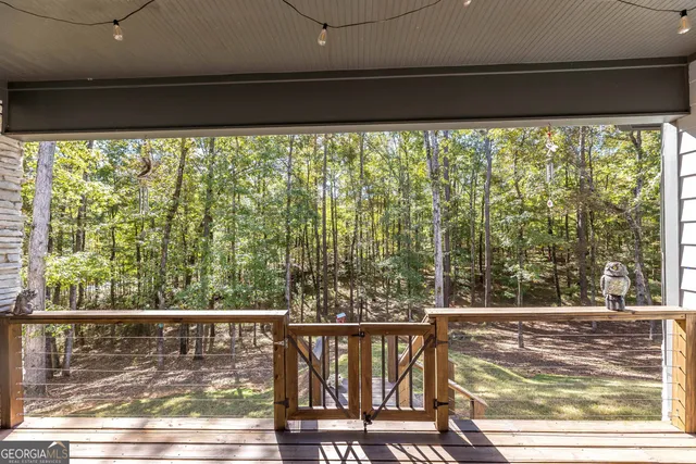 a view of a chairs and table in patio with a backyard